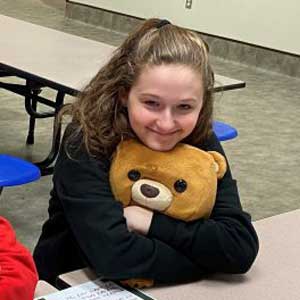 Brown County middle schooler holding a teddy bear