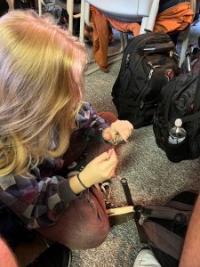 Student sitting on the ground trying to pick a lock