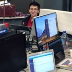 student sitting behind a computer