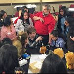 Joshua Streiff with a group of middle to high school aged kids working on a project